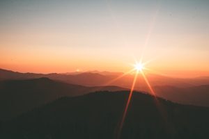 Traveler standing on cliff overlooking valley