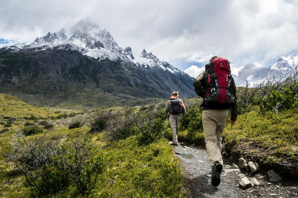 Hikers walking along a mountain ridge at sunrise during an expedition